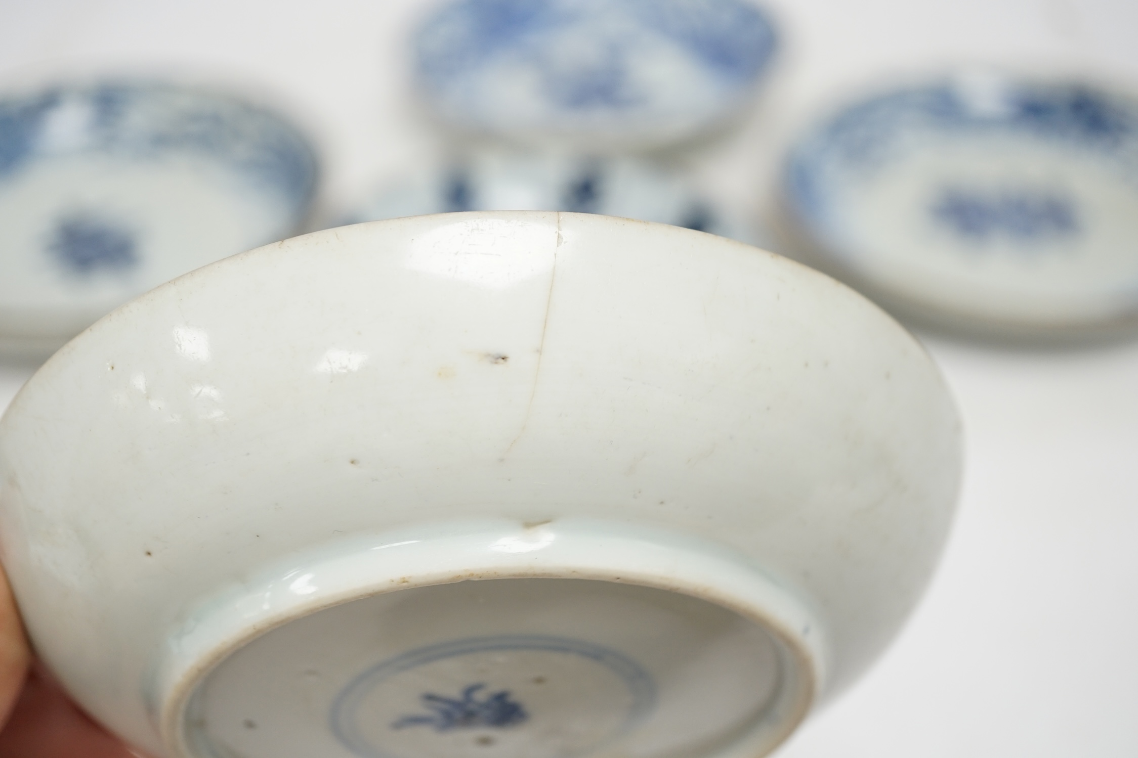 Five variously patterned Chinese blue and white saucer dishes, Kangxi period, largest 16cm diameter. Condition - chips and cracks to three items